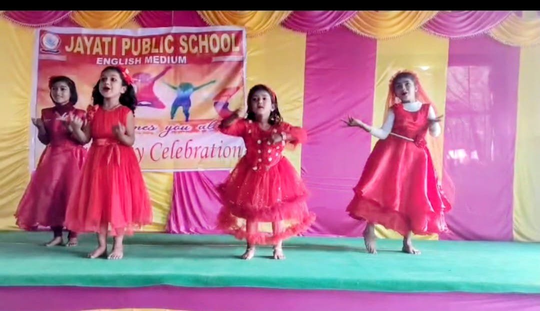 Girls in red dresses performing cultural dance