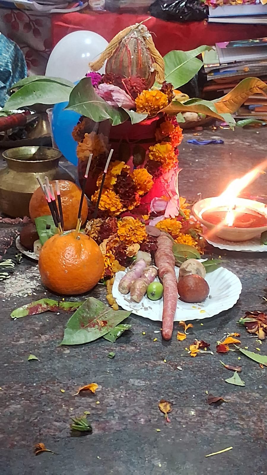Puja offerings and lamp lit for Saraswati Puja