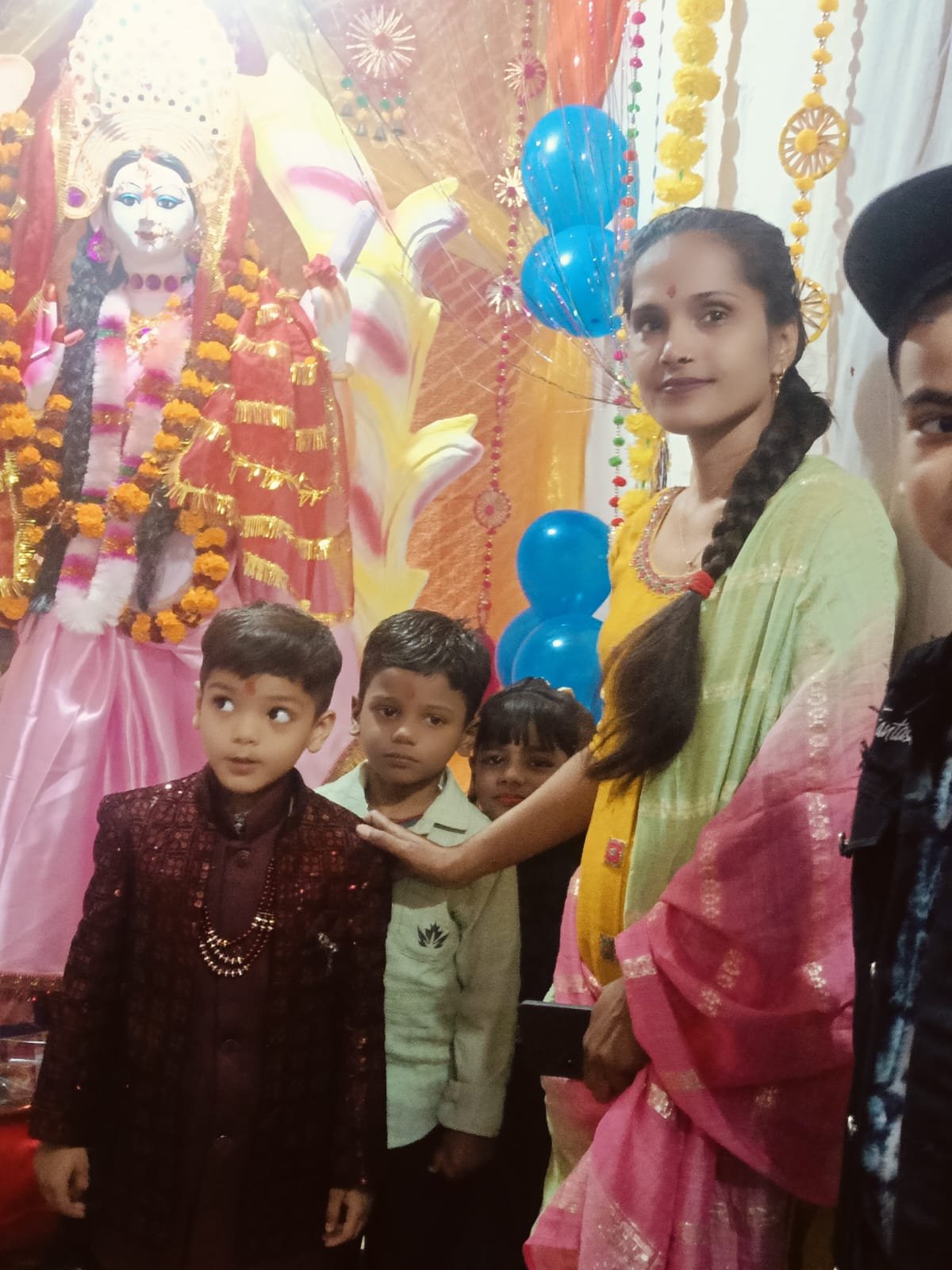 Teacher and students gathered for Saraswati Puja